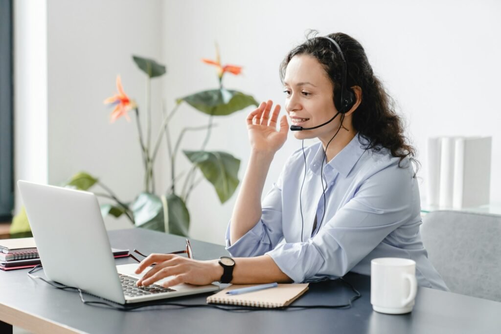 Confident caucasian IT support call center female worker in headset watching