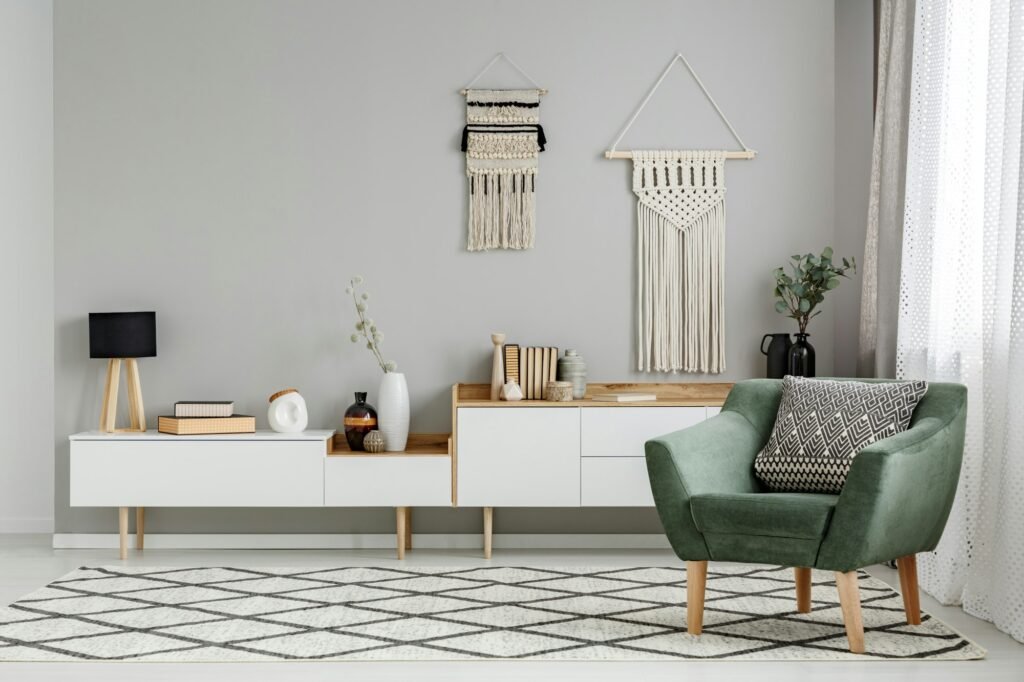 Green armchair on patterned carpet in bright living room interio
